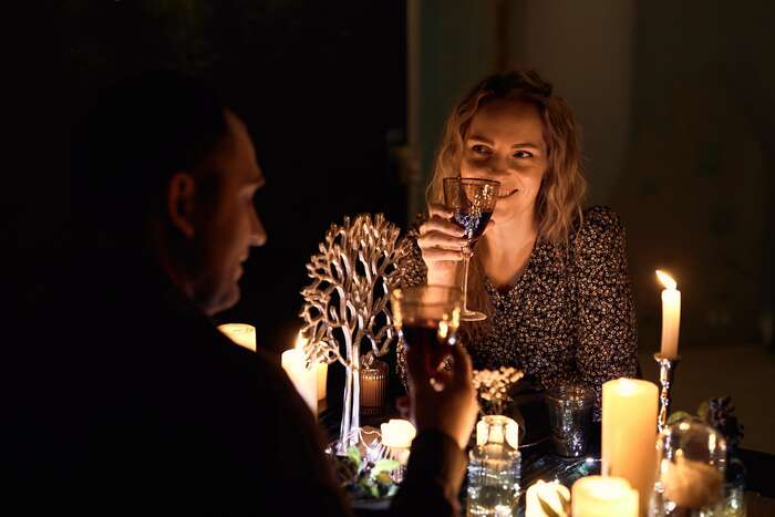Romantic couple sharing a candlelit dinner