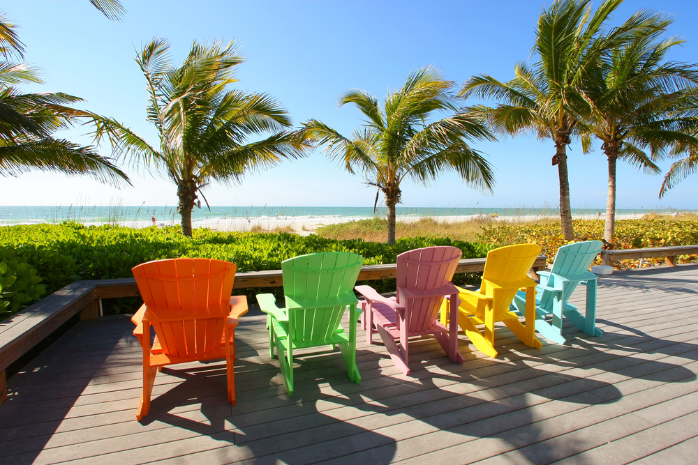 Colorful beach chairs and palm trees on Anna Maria Island