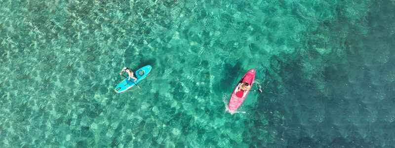 Aerial view of a couple paddleboarding in a tropical bay near Anna Maria Island